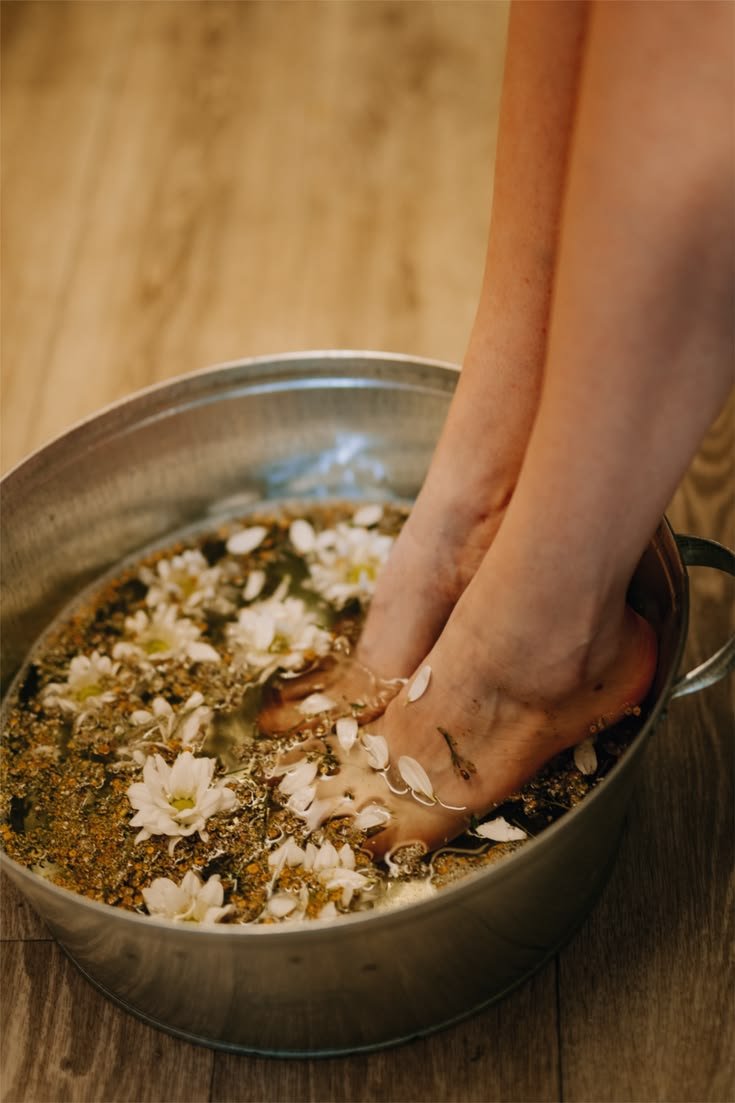 Feet in a herbal floral foot bath
